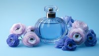 Elegant glass perfume bottle with blue fragrance surrounded by delicate pink and purple ranunculus flowers on soft blue background, luxury cosmetic styling.