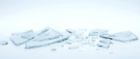 Shattered glass pieces scattered on white surface, isolated fragments ready for design projects, backgrounds, and creative compositions.