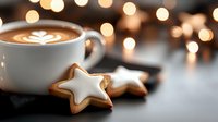 Hot cappuccino with latte art and star-shaped Christmas cookies on dark background with festive bokeh lights, cozy winter holiday atmosphere.