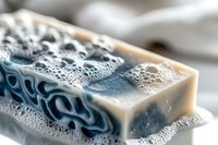 Natural handmade soap bar with rich lather and bubbles for skincare and hygiene routine in bathroom setting.