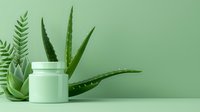 Fresh aloe vera leaves with green succulent plant and cosmetic cream jar on mint background, natural skincare and beauty concept.
