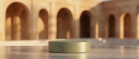 Golden cylindrical podium on marble surface with blurred arched architecture background, luxury product display stand for cosmetics and premium brand presentation.