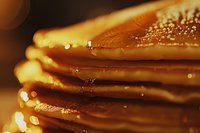 Stack of golden pancakes with dripping maple syrup and butter in warm morning light, extreme close up macro shot showing texture and glistening details.