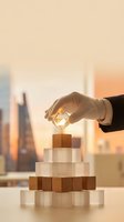 Businessman in formal attire placing golden cube on wooden block pyramid against urban skyline at sunset, symbolizing business growth, strategy and success for corporate concepts.
