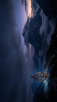 Solitary boat navigates misty mountain fjord at dawn, surrounded by towering rocky cliffs and atmospheric fog, evoking adventure and isolation in remote wilderness.