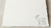 Minimalist line drawing of a goat on cream textured paper, isolated on white background, suitable for branding, stationery design, and print projects.