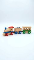 Wooden toy train set with locomotive, coal car, and passenger car featuring colorful wheels and blocks on white background for children's play and education.