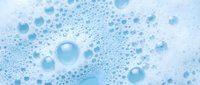 Blue soap bubbles and foam texture background for cleaning products, bath cosmetics, and hygiene advertising campaigns.
