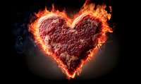 Burning heart shape with intense orange flames and smoke against dark background, symbolizing passion, love and intense emotions.