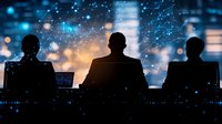 Silhouettes of three business professionals at computer workstations against glowing blue digital network background, representing cybersecurity operations center.
