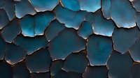 Cracked turquoise surface with dark edges creating abstract pattern. Deep blue-green aged texture shows weathered segments with burnt borders. Artistic background.