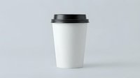 White disposable coffee cup with black lid isolated on gray background for branding mockup and cafe marketing materials.