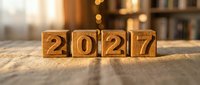 Wooden blocks spelling 2027 on a linen surface with warm bokeh background, symbolizing new year planning, goals, and future business strategy.