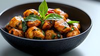 Roasted baby potatoes with fresh herbs and garlic in dark ceramic bowl, crispy golden skin, restaurant quality side dish for culinary presentations.