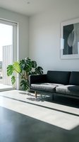 Modern living room with black and gray sofa, potted monstera plant, floor-to-wall window, and minimalist wall art for contemporary home decor.