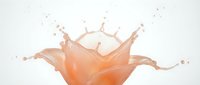 Orange liquid splash creating crown-like formation with droplets against white background. Dynamic fluid motion for beverage advertising and design projects.