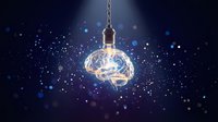 Glowing brain inside transparent light bulb hanging on cord against dark blue background with sparkling particles representing innovation and creative thinking.