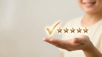Young woman holding glowing five star rating with golden checkmark above open palm representing customer satisfaction and quality service feedback.