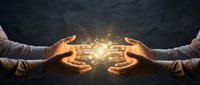 Two hands holding glowing circuit board technology between them against dark background, representing digital connection, innovation, and shared technological advancement.
