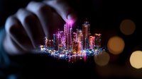 Glowing miniature futuristic cityscape with neon pink and blue lights held between fingers against dark background with bokeh effects creates magical urban scene.
