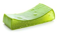 Fresh cut aloe vera leaf segment with water drops on bright green gel surface, isolated on white background for natural cosmetic and skincare products.