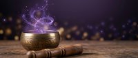 Tibetan singing bowl with magical purple energy swirls and wooden mallet on rustic surface against bokeh background for meditation and spiritual healing practices.