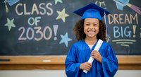 Young African American girl in blue graduation cap and gown holding diploma with Class of 2030 chalkboard background. Educational achievement concept.