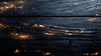 Dark textured background with golden glowing accents creating dramatic contrast. Abstract black surface with metallic shimmer effect and flowing lines suitable for luxury designs.