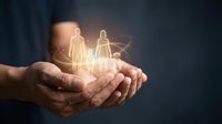 Hands protecting glowing family figures symbolizing life insurance, healthcare coverage, and financial security for loved ones.