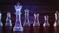 Glass chess pieces with glowing purple and blue lighting creating dramatic atmosphere for strategic thinking and business concepts.