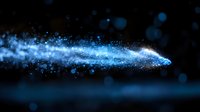 Glowing blue particle trail with sparkling light effects and bokeh on dark background creates magical atmosphere for fantasy designs.