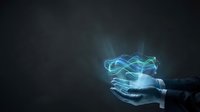 Businessman hand holding glowing blue energy waves with magical light effects on dark background for technology and innovation concepts.