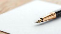 Elegant gold fountain pen with silver nib on white paper against wooden surface, shallow depth of field. For business, writing, and luxury lifestyle concepts.
