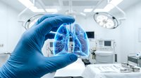 Gloved hand holding digital lung hologram in modern operating room with medical equipment and surgical lights overhead.