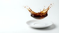 Liquid splashing dynamically above empty white plate on neutral background, capturing motion and energy for beverage, food, and culinary advertising.