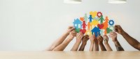 Diverse hands lifting colorful community icons including people, house, and gear symbols together, representing teamwork, unity, and collaborative support for social causes.