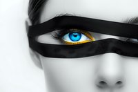 Striking close-up of bright blue eye with black ribbon across face creating dramatic contrast on desaturated background, artistic fashion portrait composition.