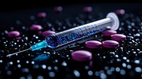 Medical syringe with blue liquid surrounded by purple pills and scattered glitter particles on dark background, dramatic lighting for healthcare concept.