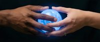 Cupped hands protecting glowing blue energy sphere against dark background symbolizing care, protection, innovation and sustainable future concepts.