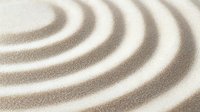 Minimalist zen garden sand pattern with concentric circles creating peaceful ripple effect, meditation and wellness concept for spa and relaxation designs.