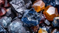 Colorful raw crystals and mineral stones macro photo showing natural texture and formation. Blue sapphire, amber and quartz specimens in geological collection.
