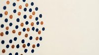 Scattered navy blue and orange dots on cream background creating modern minimalist pattern for contemporary design projects and branding materials.
