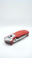 Red folding pocket knife with ergonomic grip handle isolated on white background for product photography and commercial use.