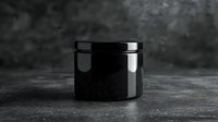Black cosmetic jar on dark textured background with reflection. Minimalist product photography for beauty and skincare packaging mockup presentation.