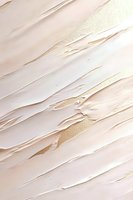 Luxurious cream and gold abstract texture with diagonal brush strokes creates elegant modern background for luxury branding and interior design projects.