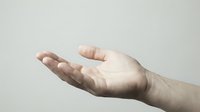 Caucasian male hand with open palm facing upward in receiving or offering gesture against neutral background, isolated for design use.