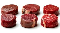 Six fresh raw beef tenderloin steaks arranged on white background, isolated, showcasing rich red color and marbling for food and culinary use.