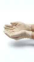 Pair of beige cotton work gloves worn on open hands in cupped position, suitable for safety, protection, labor, and industrial applications.