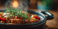 Savory braised meat stew with fresh rosemary garnish simmering in cast iron pot. Comfort food cooking concept for restaurant menus and culinary blogs.