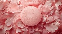Pink bath bomb on delicate carnation petals background in monochromatic coral color scheme creates luxurious spa and beauty composition.